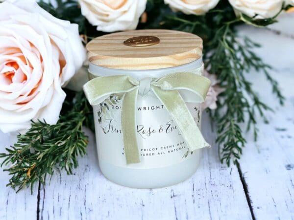 Scented candles with wooden wicks by Donna Wright Designs in French Rose & Evergreen 12 oz sitting on an antique wooden table. The best romantic fragrance combination!