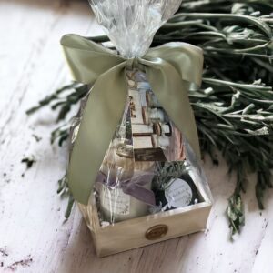 A gift basket with a Noble Fir & Juniper - 4 Oz in it.