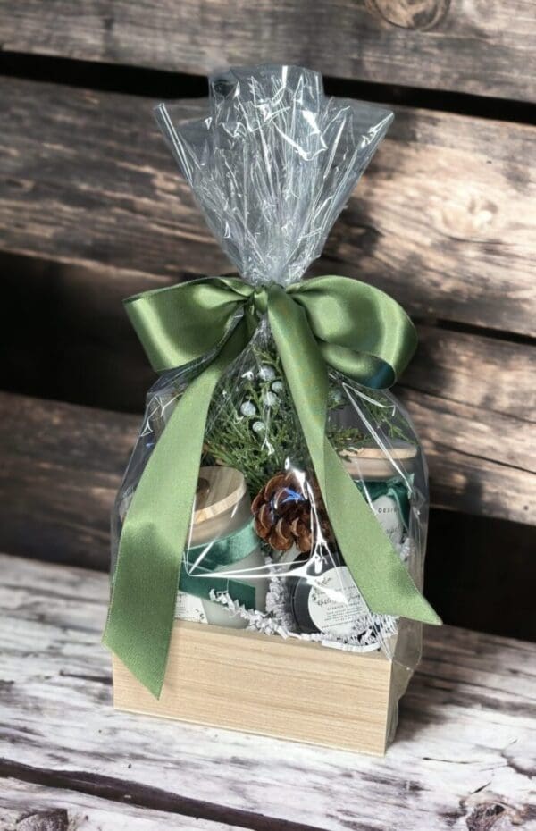 Noble fir & juniper gift basket by Donna Wright offers the perfect luxury candle gift basket in a wood box wrapped in cellophane with a satin ribbon