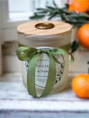 Luxury citrus green candle styled in a modern home interior with natural decor.