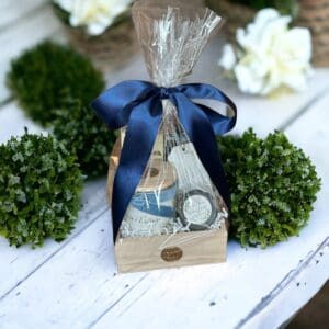 Gardenia & Tuberose gift basket medium with luxury perfume grade candles by Donna Wright Designs with scented hand soap, travel candle & matches in a wooden box wrapped with cellophane and dark blue ribbon