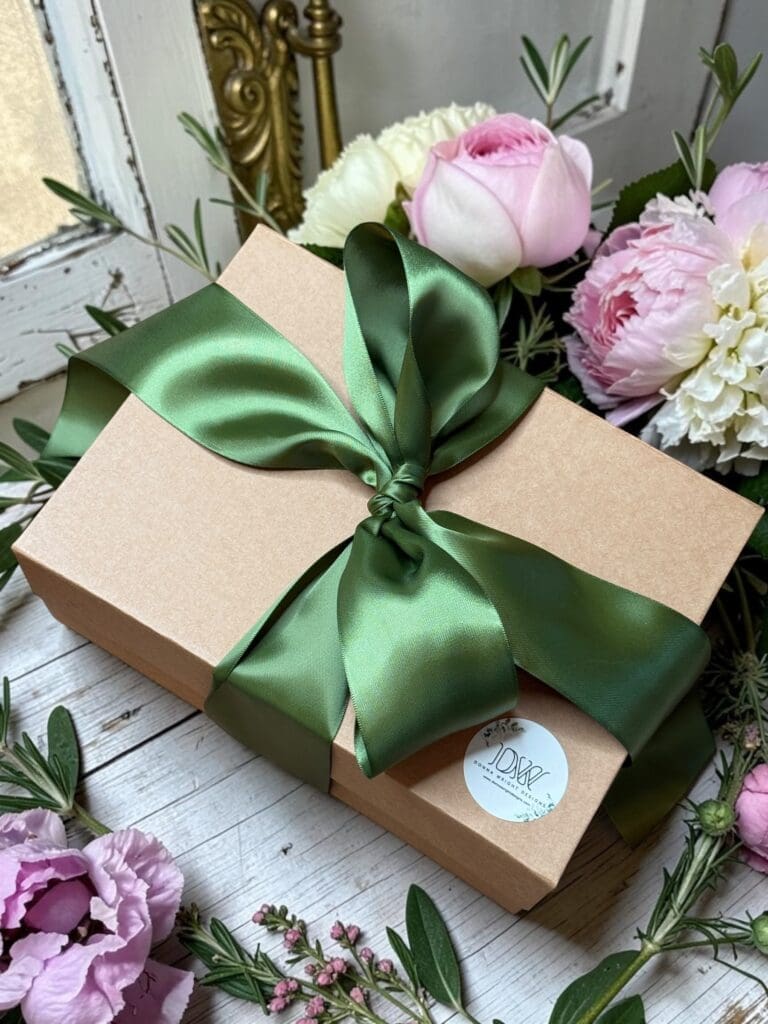 Mother's Day gift box with Donna Wright Designs candles in brown craft paper box with olive green ribbon.